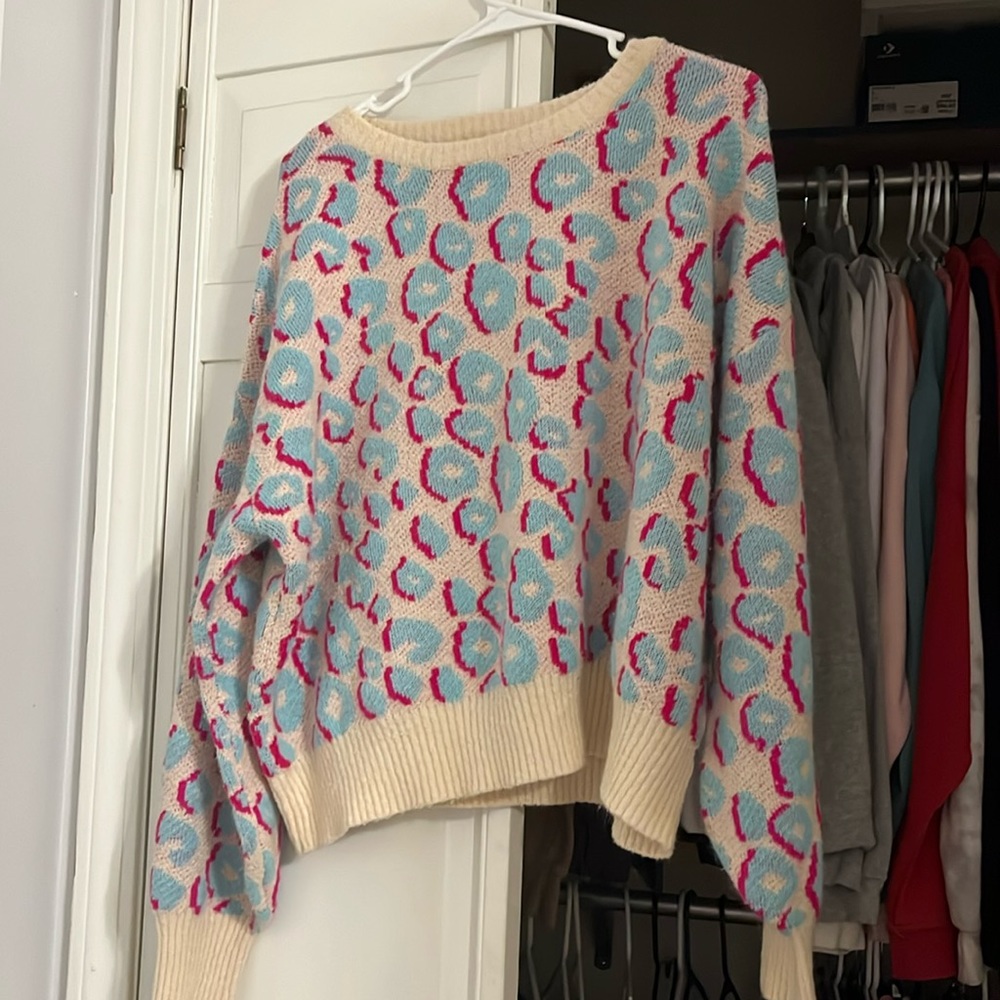 this sweater is from vernon, cali from a shop named “peach love california”.
